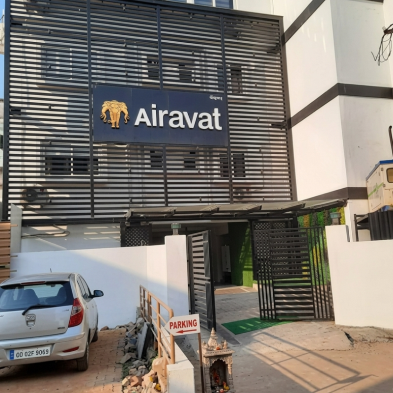 Building exterior with 'Airavat' logo and a parked car.